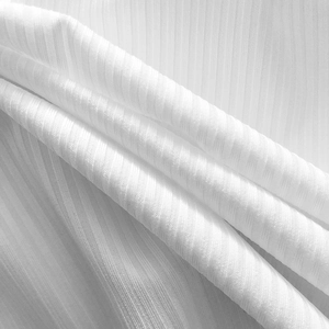 Close-up of white ribbed knit fabric showing soft texture and vertical stripe detail