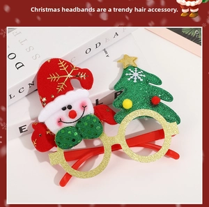 Detail of Christmas glasses featuring Santa Claus and tree decorations on white book