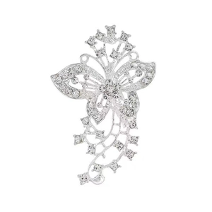 Detailed close-up of a silver butterfly brooch with sparkling crystals and tassels