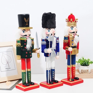 Three 30cm wooden nutcracker soldiers in red, blue and green with velvet details