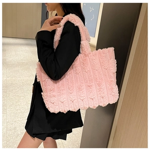 Detailed close-up of pink faux fur tote bag showing plush texture and vertical stripes