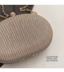 Close-up of champagne gold sequined evening clutch with rhinestone clasp and chain strap