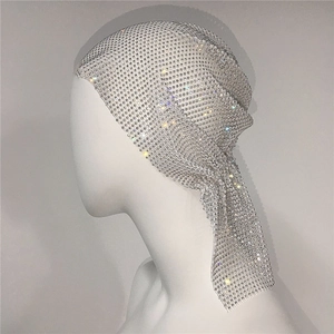 Detailed close-up of sparkling rhinestone mesh headscarf on a white mannequin head