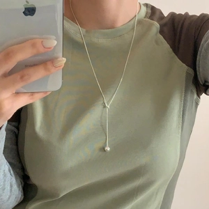 Detailed mirror selfie showing a delicate 925 sterling silver heart necklace on neck