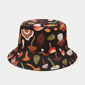 Close-up of mushroom and botanical patterns printed on a black cotton bucket hat
