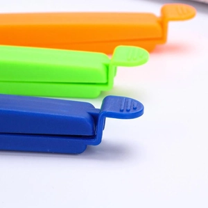 Blue, green and orange plastic food sealing clips for kitchen snack bag storage