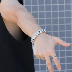 Close-up of a silver stainless steel motorcycle chain bracelet worn on a man's wrist