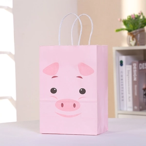 Pink cartoon pig paper gift bag with white rope handles on a stylish bookshelf background