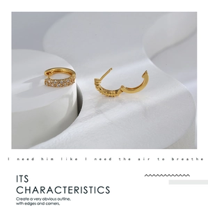Detailed close-up of gold-plated hoop earrings with micro-set white cubic zirconia stones