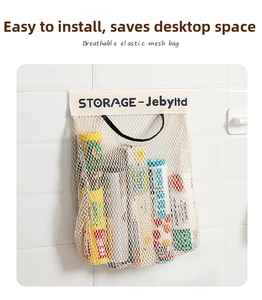 Detail of wall-mounted mesh storage bag with reinforced canvas top and durable netting