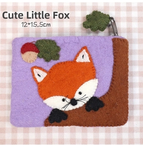 Detail of cute fox felt coin purse with floral embroidery on purple fabric
