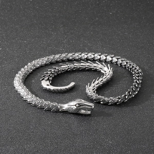 Macro detail of retro steel snake necklace showing intricate scale textures and snake head