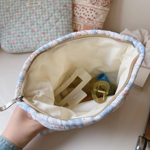 Internal view of quilted floral makeup bag showing inner lining and spacious capacity