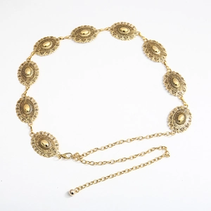 Detail of vintage gold metal waist chain featuring engraved oval floral pattern links
