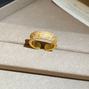 Macro shot of 24K gold plated flower ring with sparkling zircon inlays in vintage style