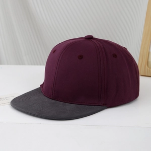 Detail of burgundy and charcoal color-block kids baseball cap with breathable twill texture