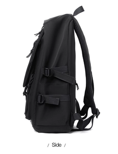 Side view of a black backpack showing breathable mesh padding and adjustable side straps