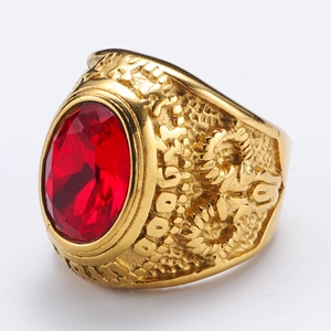 Foto macro de anillo punk con gema roja ovalada y detalles en relieve de oro