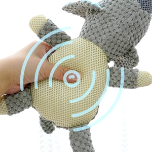 Close-up of hand squeezing plush squeaky dog toy with durable mesh and internal sounder