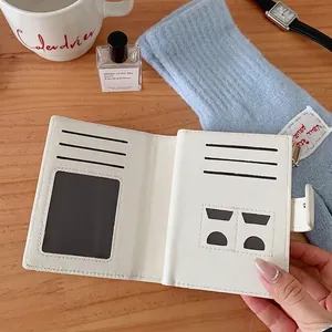 Foldable white PU leather wallet with multiple card slots and clear ID window on wood