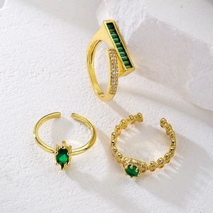 Three-piece set of 18K gold plated rings with emerald green zircon and geometric patterns