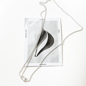 Close-up of S925 sterling silver minimalist U-link buckle pendant on fine chain necklace