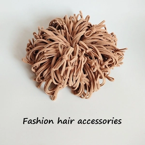 Macro shot of durable brown high-elasticity hair ties with woven fiber texture