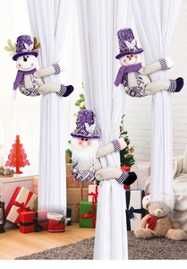 Detail of purple sequined snowman and santa claus curtain tiebacks on white curtains