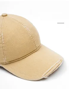 Detail of khaki cotton baseball cap with distressed brim and foldable wide visor design