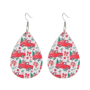 Detail of teardrop leather earrings featuring red truck and Christmas tree prints