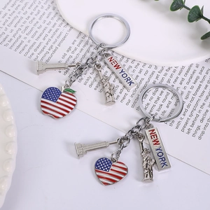 Detail of New York metal keychains with Statue of Liberty and US flag apple charms