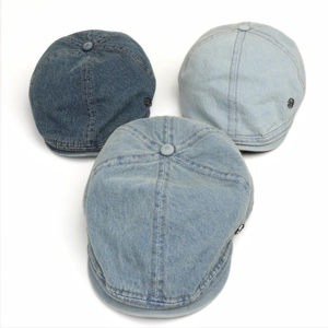 Japanese style washed denim flat caps with metal logo accents in light and dark blue