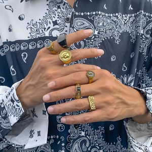 Detail of vintage men's ring set with skull and Revenge engraving on model hand