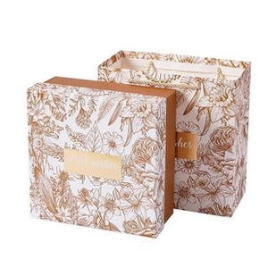 Detail of square gift box and matching tote bag with elegant gold floral line art