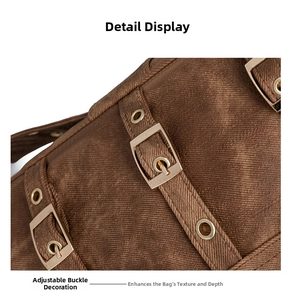 Detail view of brown washed canvas tote bag featuring adjustable bronze buckles and metal eyelets