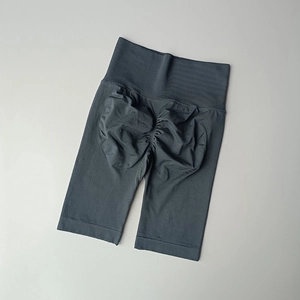 Detail of high waisted grey gym shorts showing ribbed waistband and ruched booty lifting seam