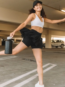 Detail view of high waisted black pleated skort with layered tutu mesh and built-in shorts