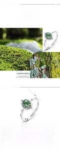 Macro detail of S925 silver ring featuring natural green moss agate and wood texture