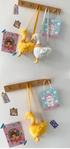 Detail of plush goose crossbody bag in white and yellow colors with soft long-pile texture