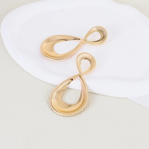 Exaggerated vintage gold water drop twisted earrings with radiant metallic texture