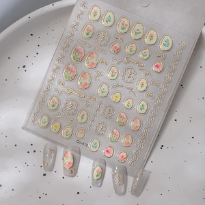 Detail of 3D embossed tulip nail stickers with gold foil lines and floral patterns