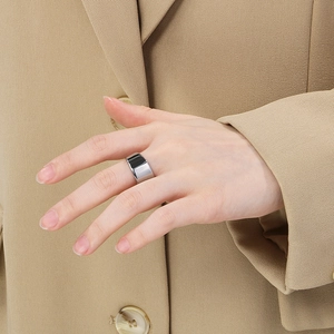 Detailed view of a wide minimalist silver stainless steel ring with a high-polished finish