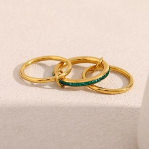 Detailed view of 18K gold plated three-layer ring set with green zircon gemstone
