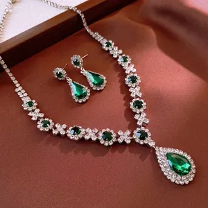 Vintage emerald water drop necklace and earring set with shimmering white diamonds