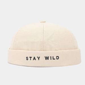 Detail of Stay Wild letter embroidery on off-white canvas docker brimless cap