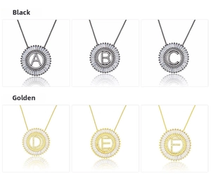 Detail view of round zircon alphabet pendants in black and golden finishes
