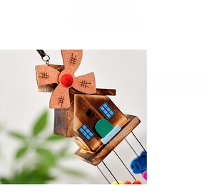 Close-up of a Japanese style wooden windmill wind chime with colorful house details