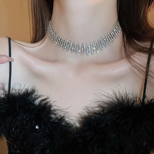 Macro detail of silver choker necklace with multi-row rhinestones on a model's neck