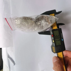 Macro view showing a digital caliper measuring 38.7 mm on an animal fridge magnet motor part