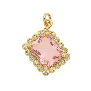 Macro detail of a copper pendant with a pink rectangular zircon and clear gem halo